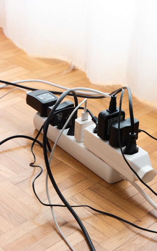 A power stip with several cords, Learn how to child-proof your home with Custom Electrical Services .
