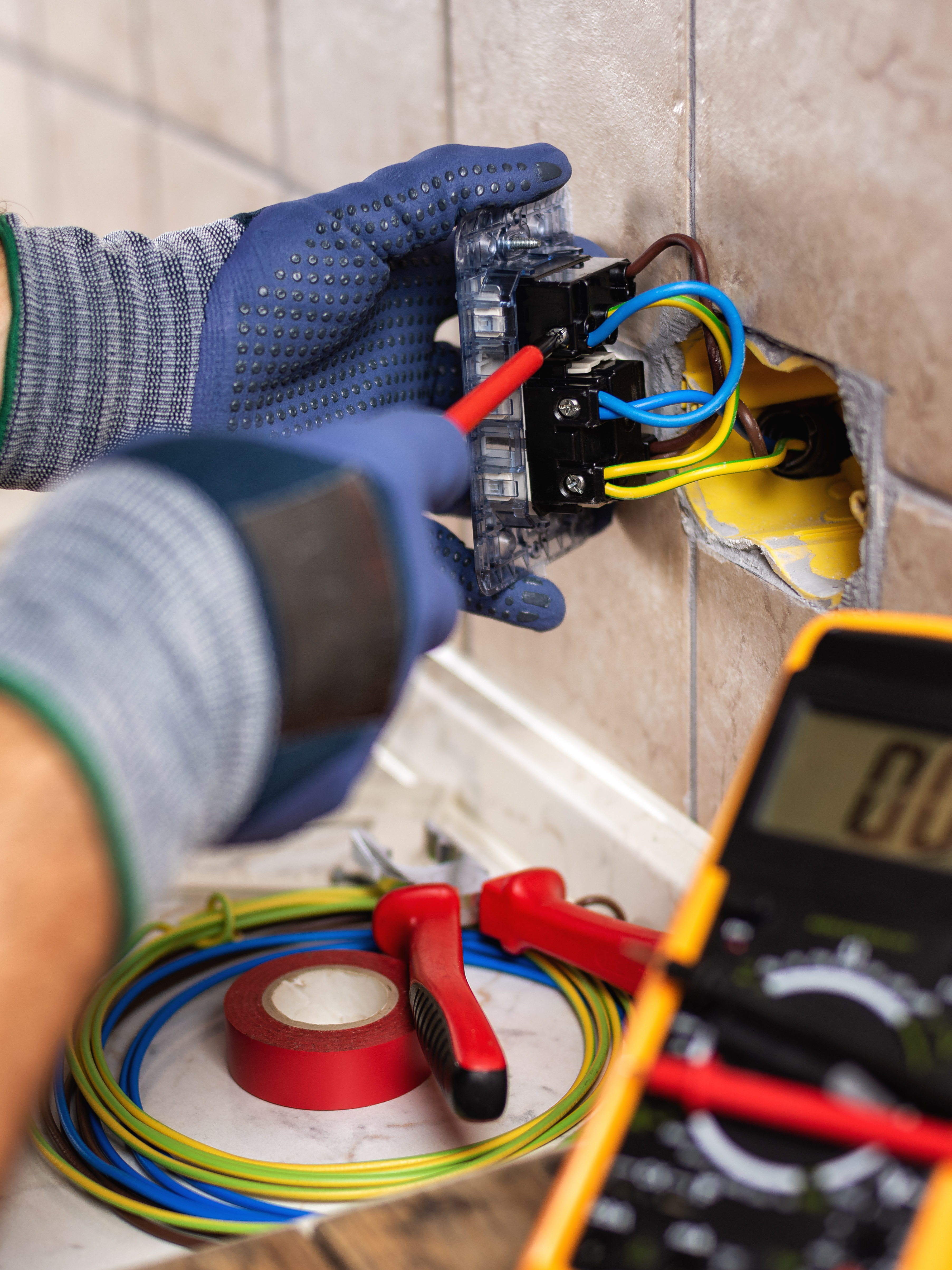 Custom Electrical working on electrical wiring in a kitchen, making sure you stay safe.