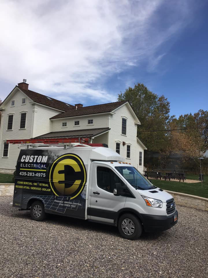 A beautifully contruscted new house with {fran_locations_name} local electricians in Utah parked out front, prepared to help with the residential wiring.