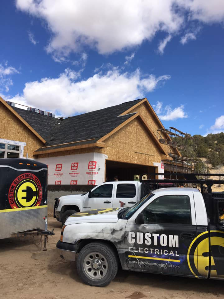 Custom Electrical parked outside a newly contructed home prepared to install their Utah residential wiring.