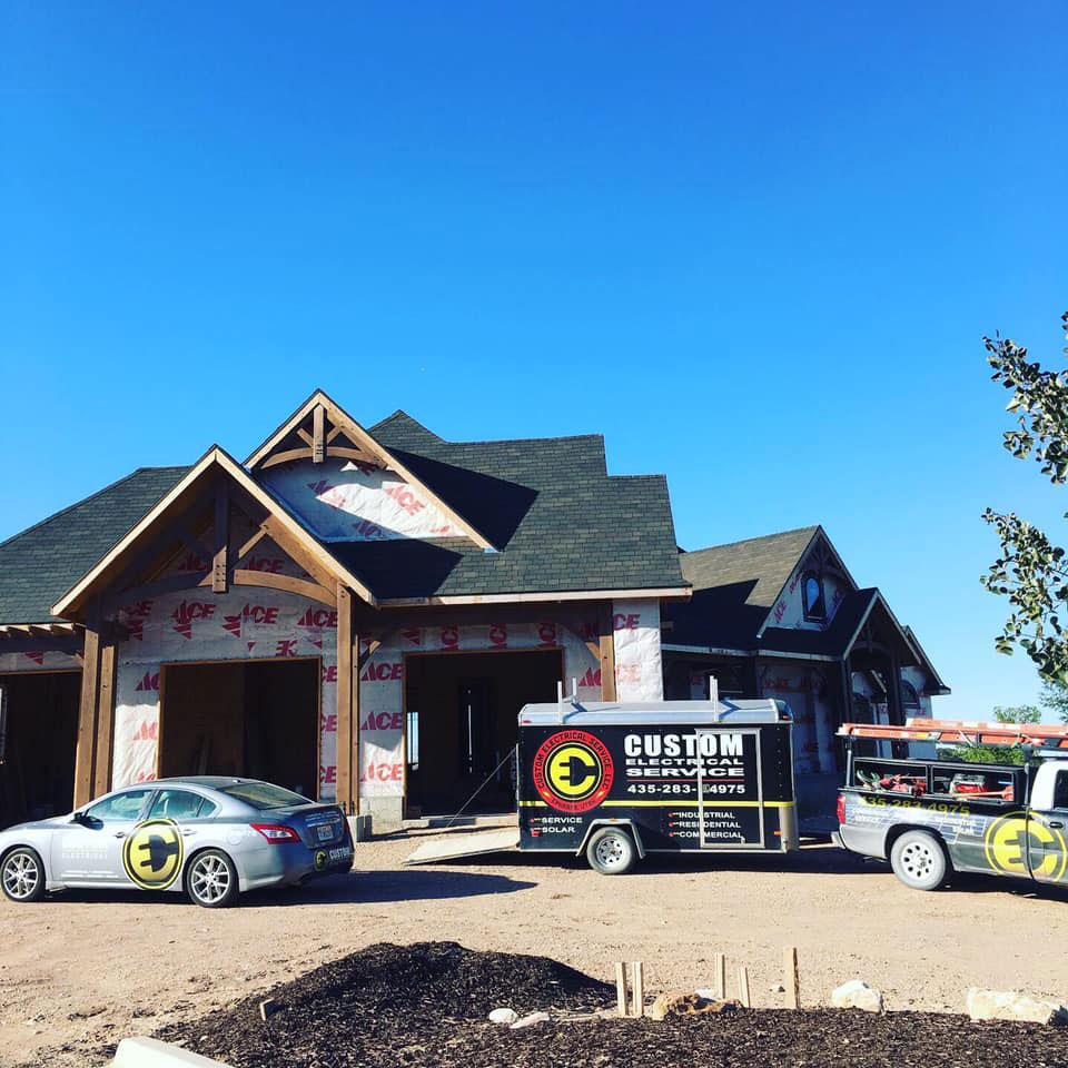 A house under construction with Custom Electrical Services  - the best electricians in Utah - parked out front.